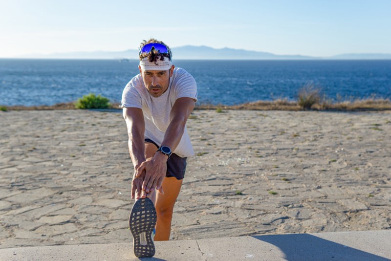 MAN STRETCHING IN THE GYM