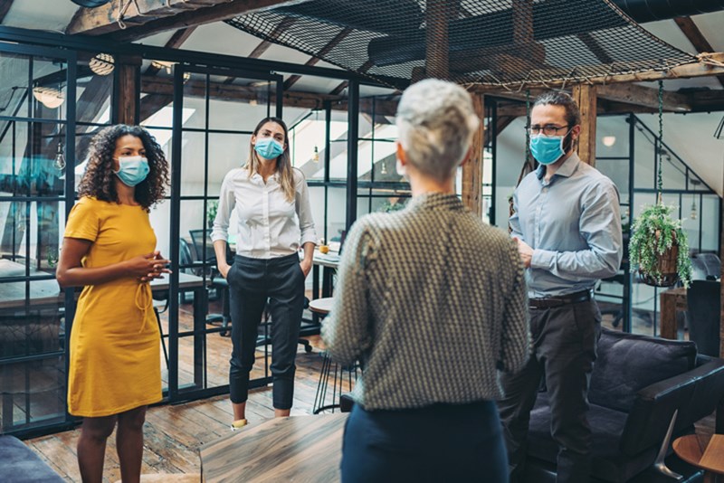 WORK TEAM OF PEOPLE WEARING FACE MASKS