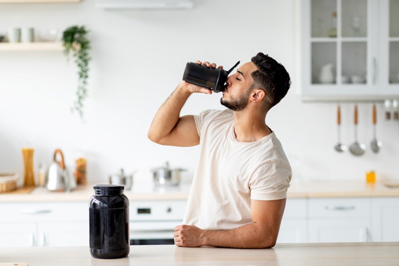 MAN HAVING A PROTEIN DRINK