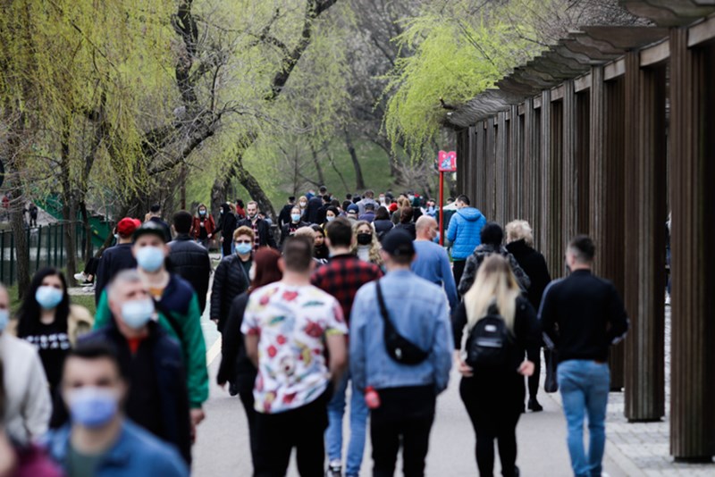 PEOPLE WITH PROTECTIVE FACE MASKS IN PUBLIC SPACE