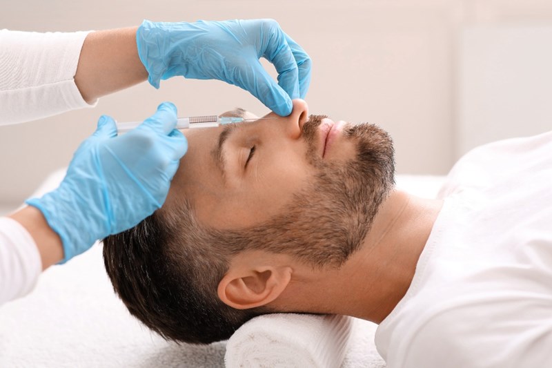 MAN UNDERGOING BEAUTY THERAPY